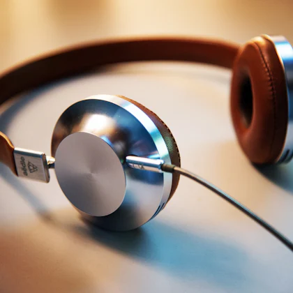 Auriculares de diadema apoyados en una mesa de madera